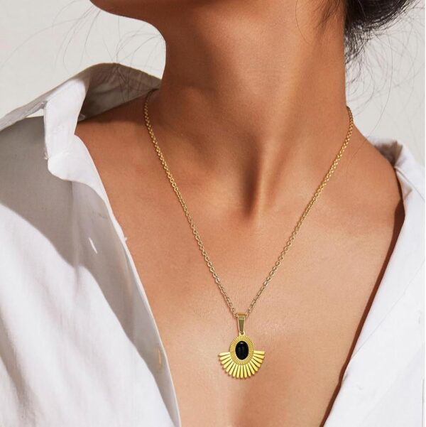 Iraasa Jewellers Sunburst Pendant Necklace—a gold-plated chain featuring a black oval stone in a radiant sunburst design.