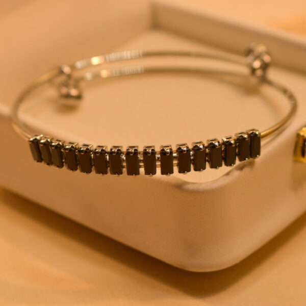 The Iraasa Collection Silver Plated White & Black Stone Bangle Bracelet is a luxurious piece designed for those who appreciate fine craftsmanship. This elegant bracelet, crafted by Iraasa Jewellers, features a premium silver-plated finish adorned with white and black stones, offering a sophisticated contrast. Whether you love timeless Bangle Bracelet Designs or a modern Half Bracelet, Half Bangle look, this piece effortlessly complements both casual and formal outfits. Its refined elegance makes it an ideal choice for those seeking stylish Bangle Bracelets for Women and Girls without compromising on exclusivity.